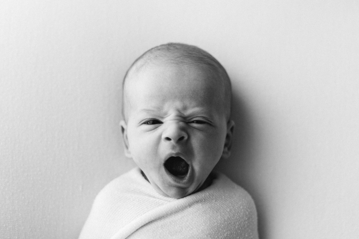 Black and white photo of baby yawning