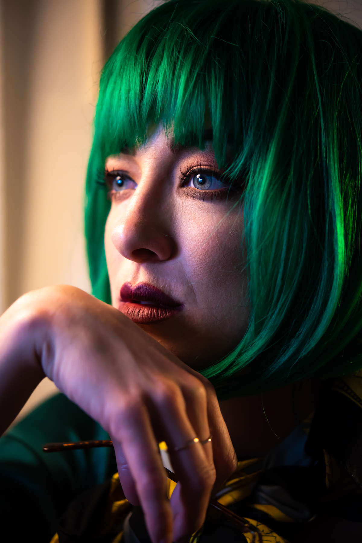 Headshot of woman with green hair