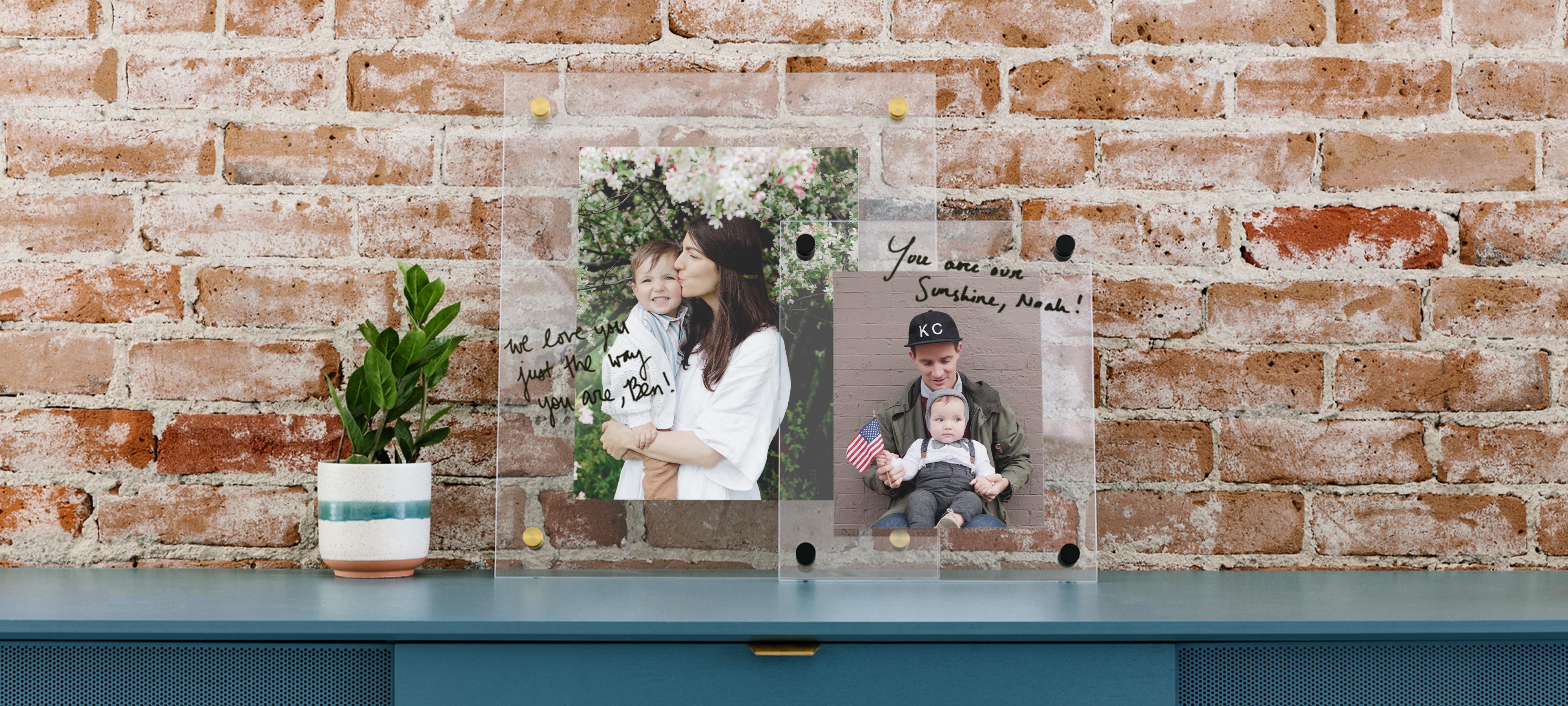 Layered floating photo frames with writing resting on dresser