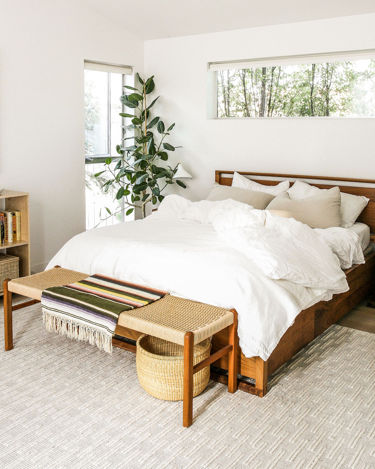 Fiddle Leaf Fig Tree in corner of minimalist bedroom with wood furniture