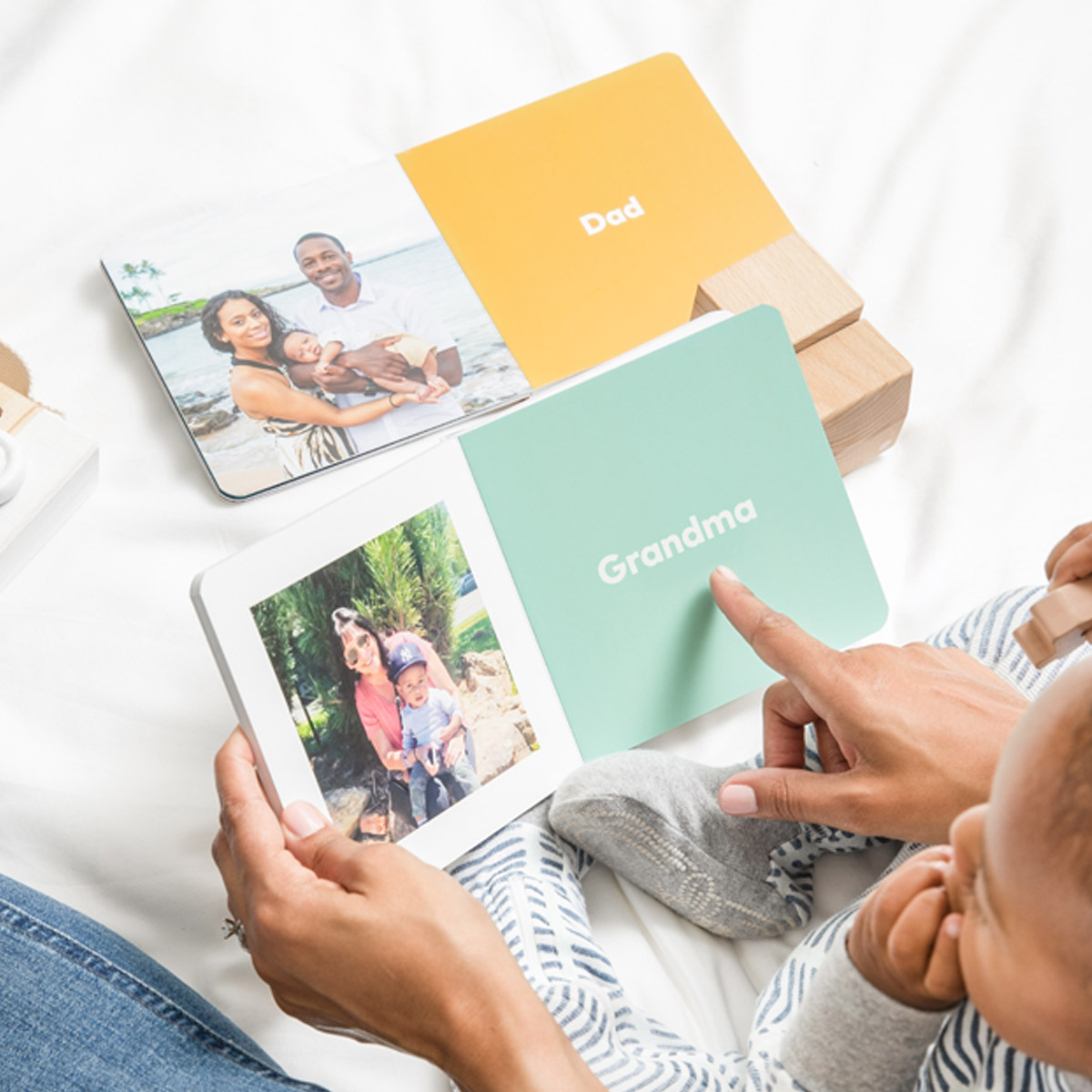 Grandmother and baby reading baby board book filled with family members