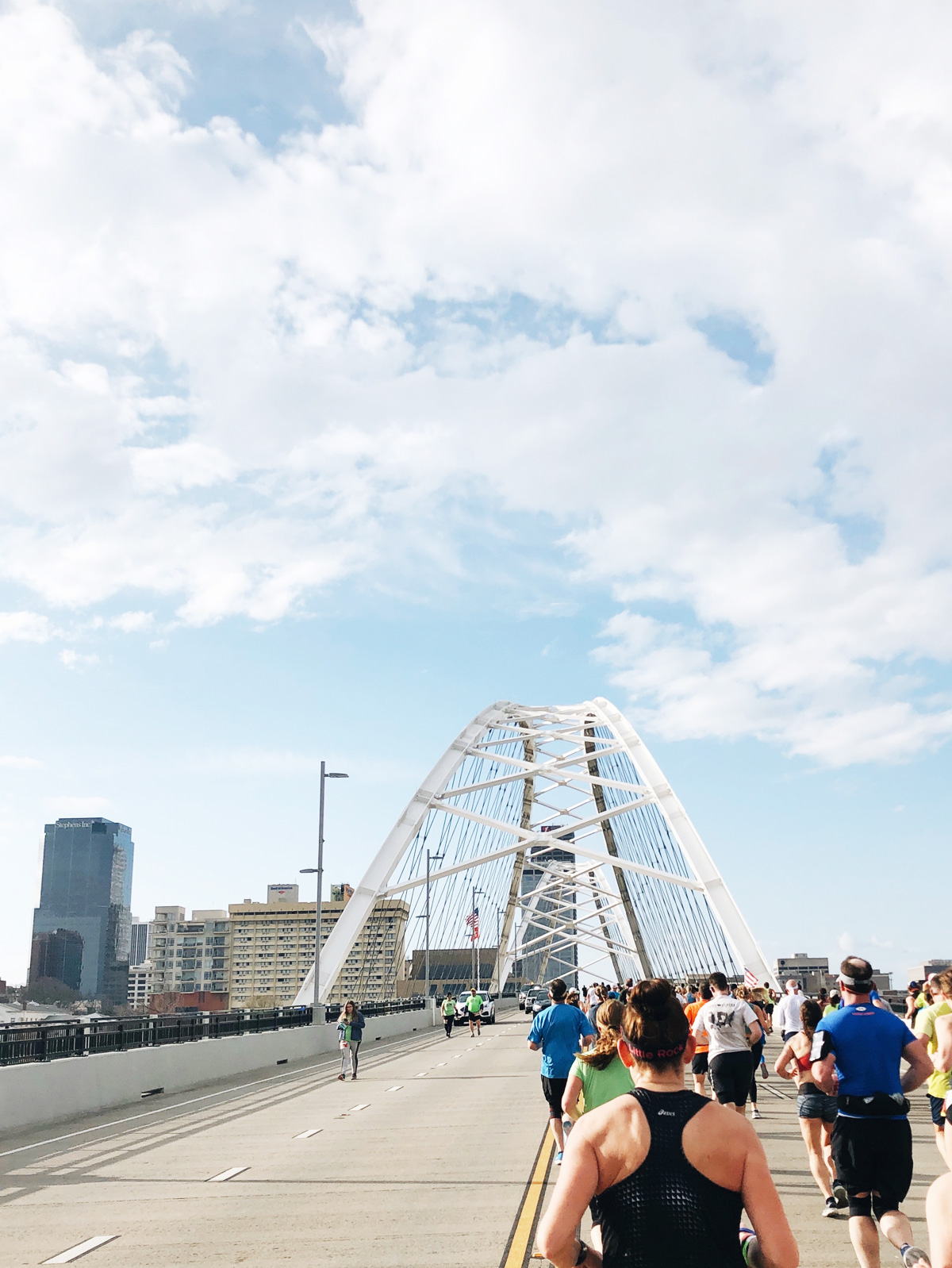 Race runners on a city bridge