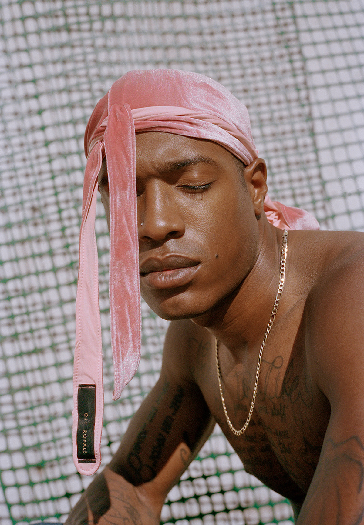 Portrait of Black man in pink durag by Adrian Octavius Walker
