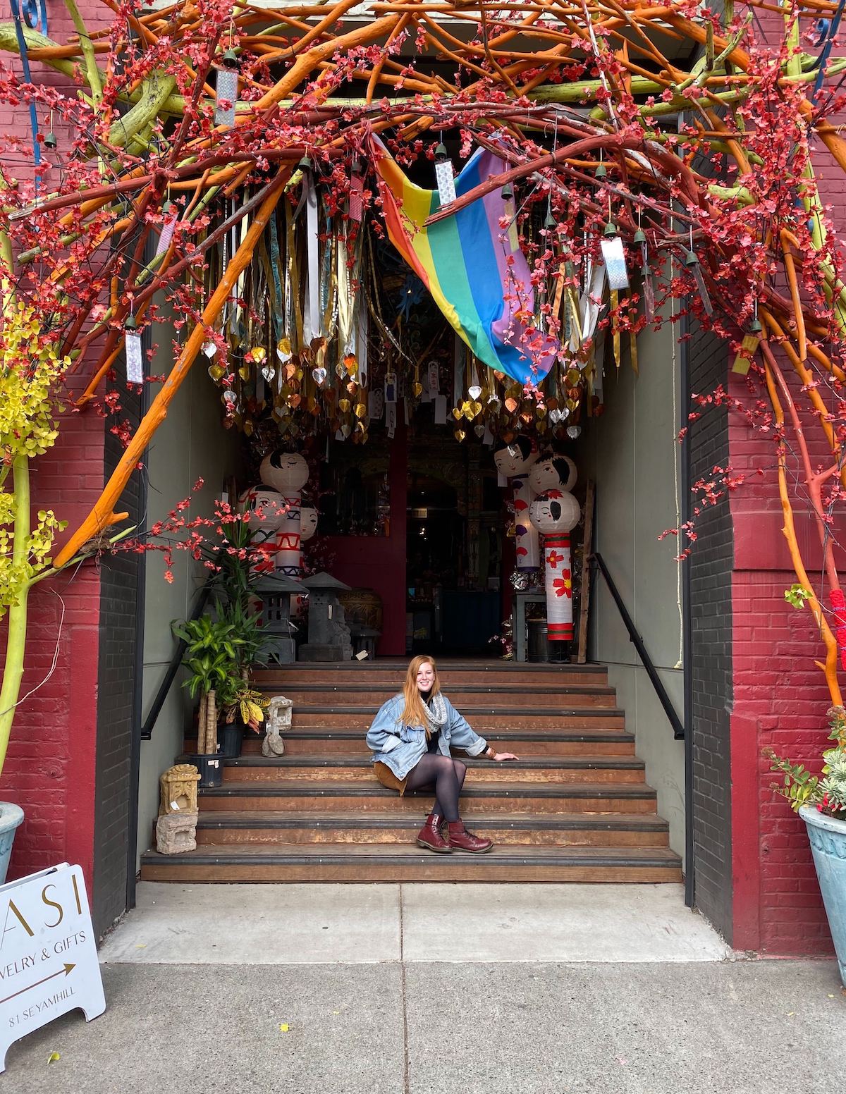 A woman on the stairs of a restaurant with an elaborate entrance
