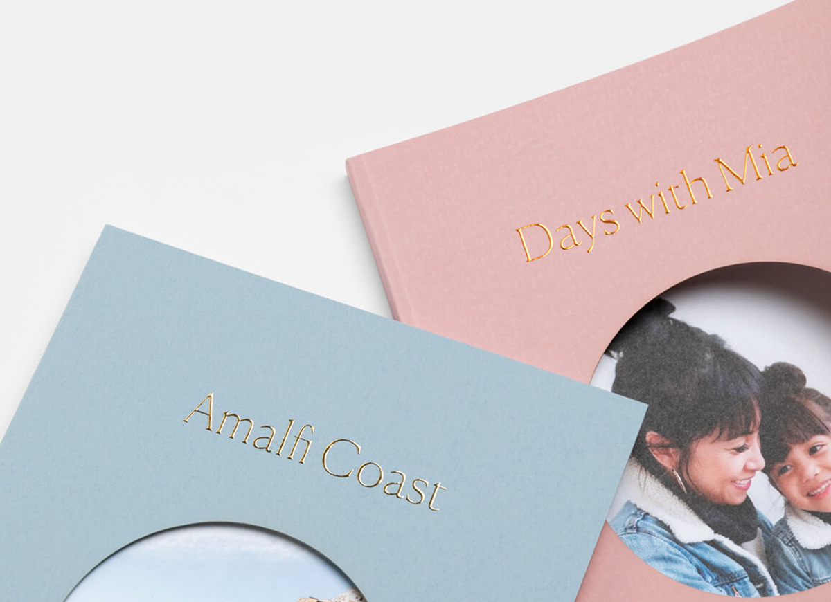 zoomed in on gold foil titles of two artifact uprising color series photo books