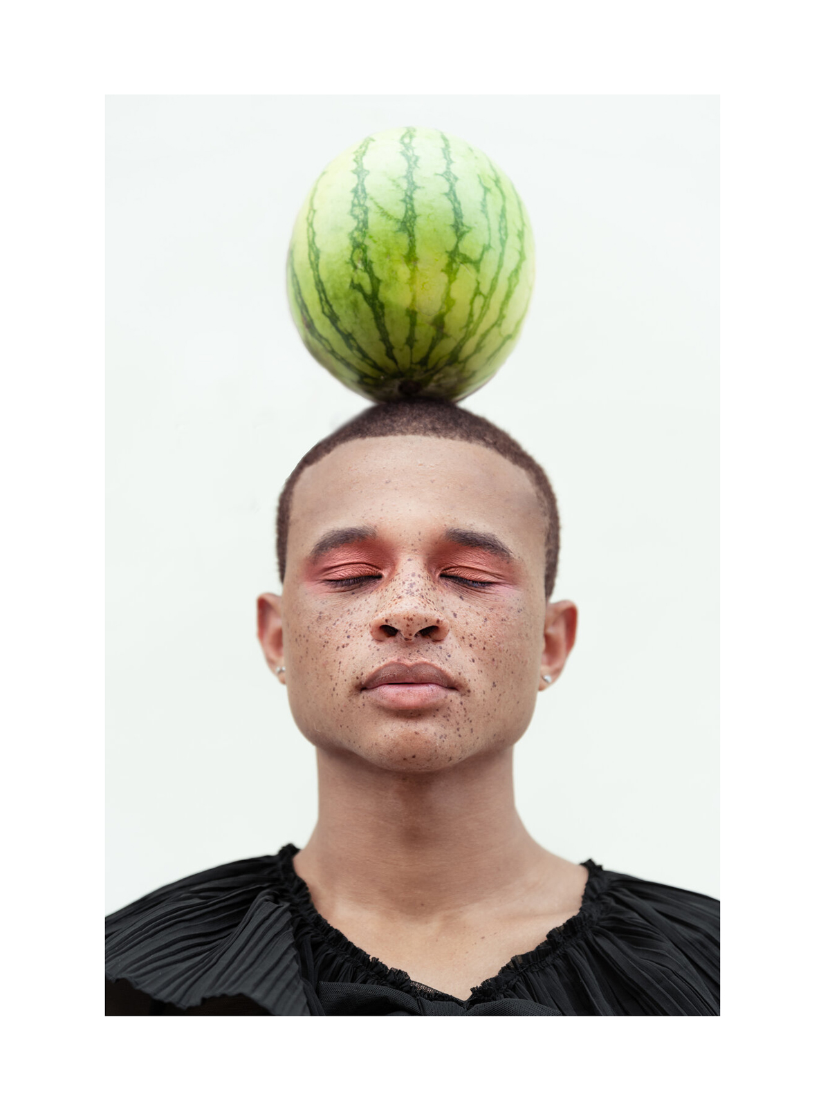 Photo by Molly Olwig of man balancing watermelon on head