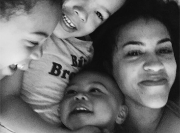 Selfie of mother snuggling with kids